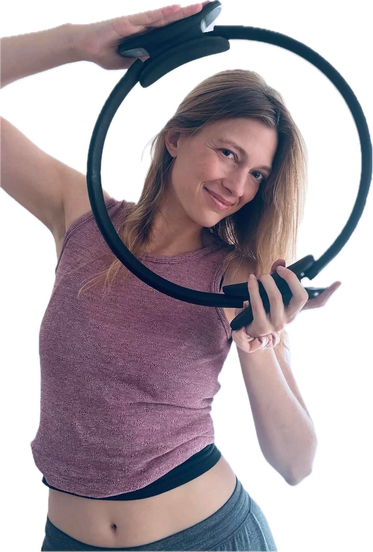 Ginny, founder and instructor of Embodied Pilates, smiling through a pilates ring